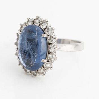 Ring with cabochon-cut sapphire and brilliant-cut diamonds.