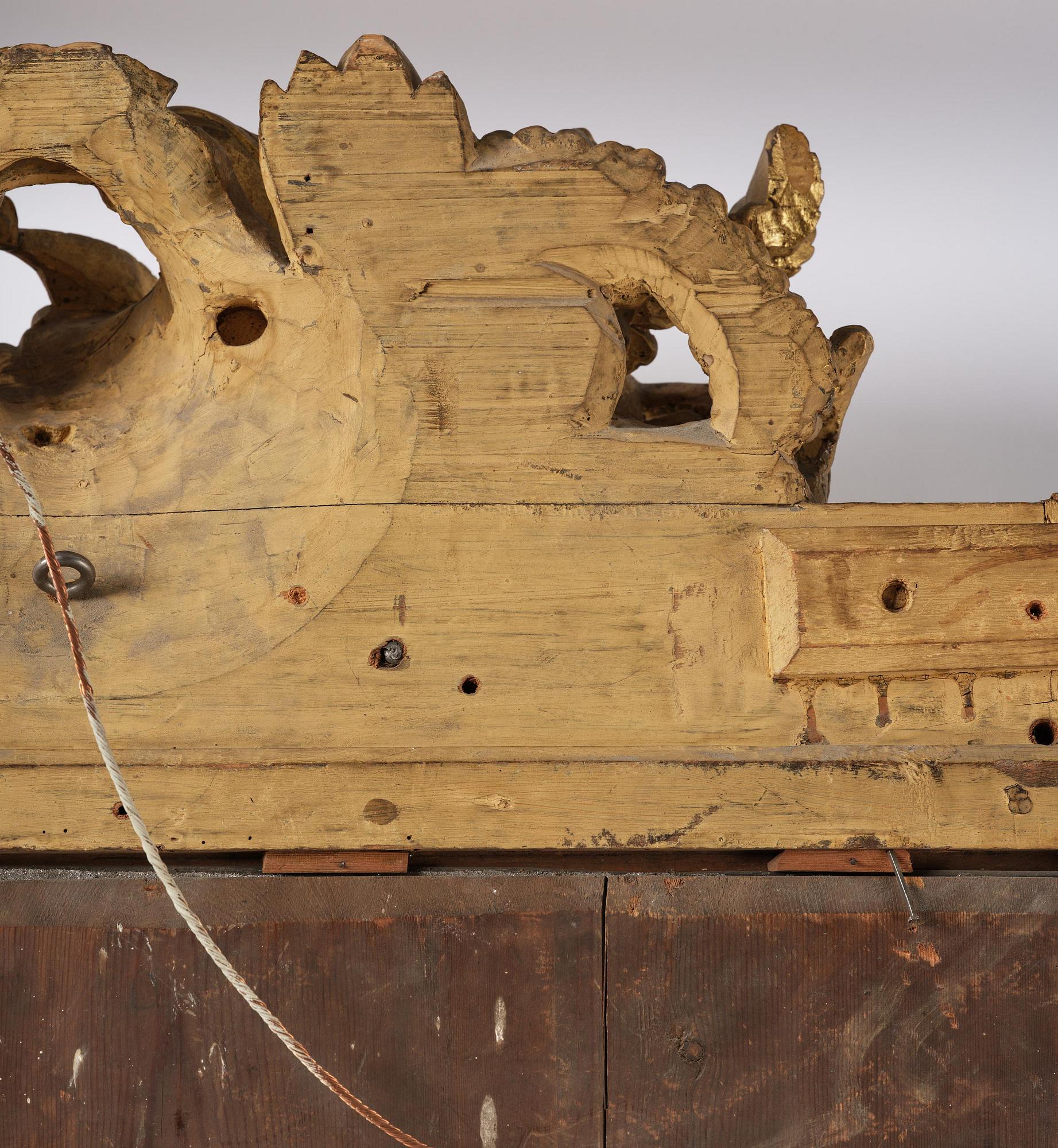 A presumably Dutch Louis XIV carved giltwood frame with mirror glass, in the style of Jean Le Pautre, late 17th century.
