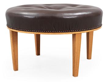 447. A Josef Frank mahogany and brown leather stool by Svenskt Tenn.