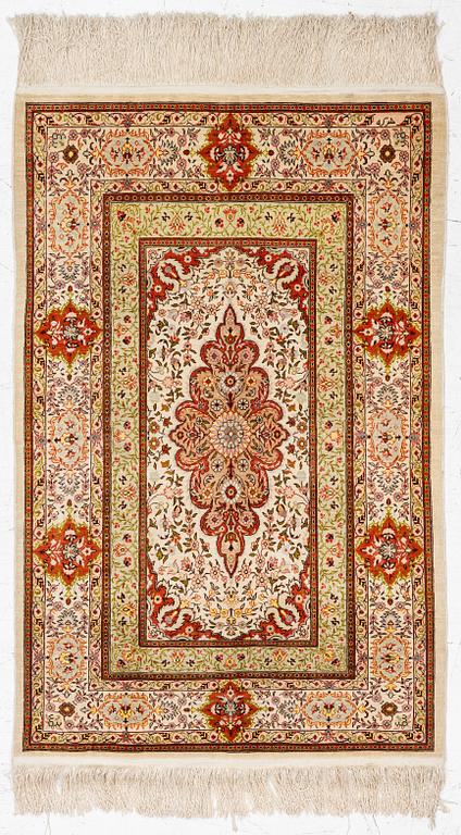A Hereke silk rug, West Anatolia, c. 107 x 69 cm.