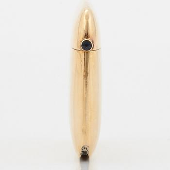 An 18K gold match case/pendant set with a faceted sapphire.