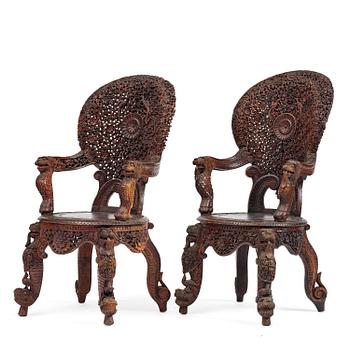 438. A pair of carved 'blackwood' armchairs, Bombay presidency, British Raj, circa 1880.