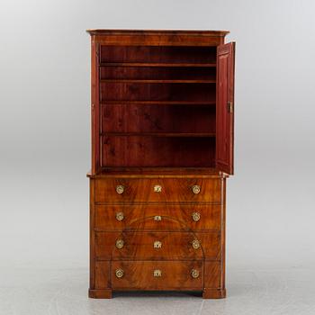 A mahogany veneered Empire cupboard, first half of the 19th century.