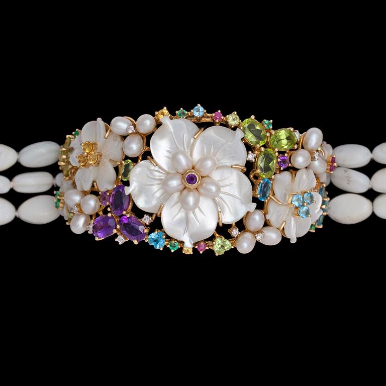 A mother of pearl and precious stone bracelet.