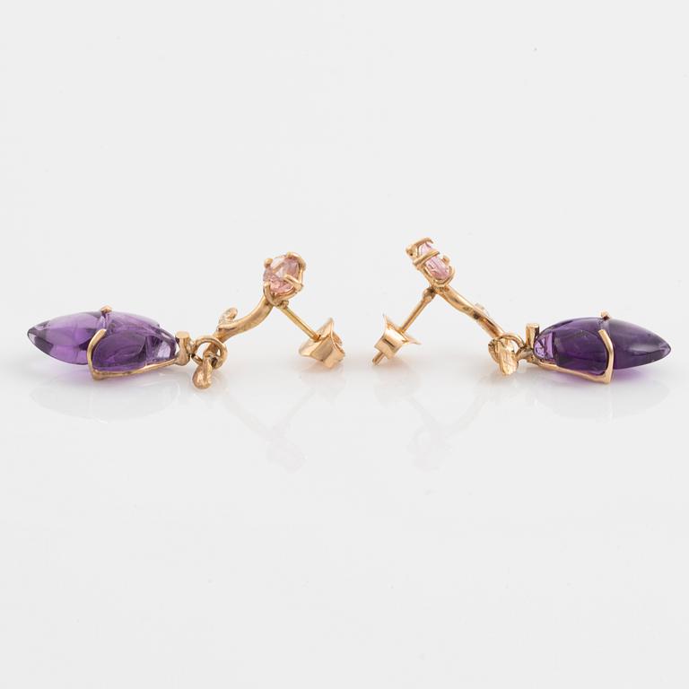 Earrings with cut amethysts, tourmaline, and small diamonds.