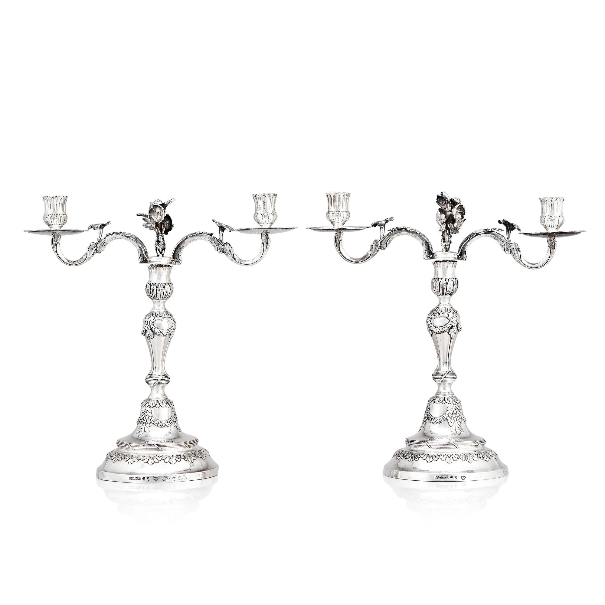 A pair of Swedish 18 century silver candelabras, mark of Lars Åkerblom Gävle 1775, arms by Christian Kullberg.