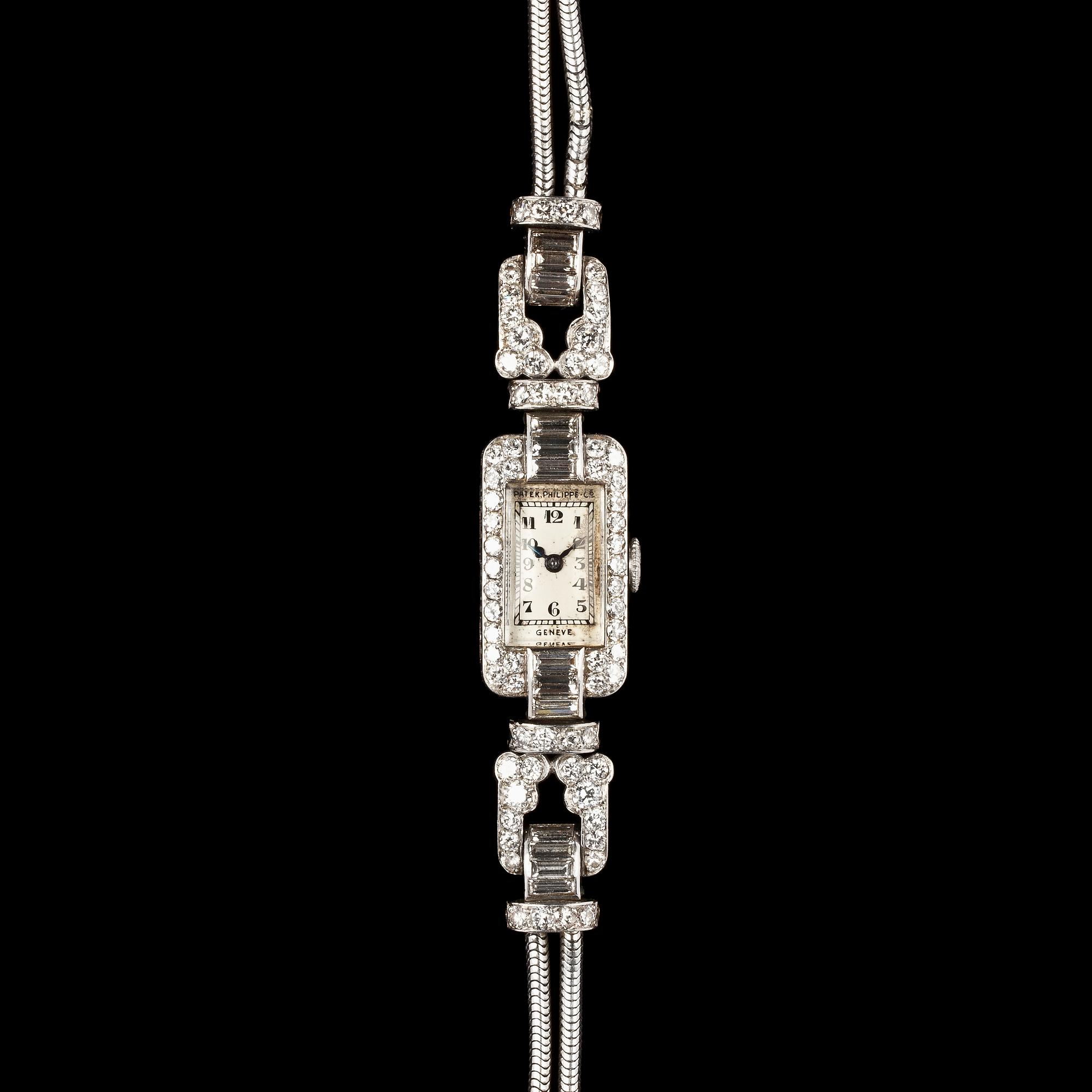 A Patek Philippe ladie's wrist watch, set with baguette- and brilliant cut diamonds, tot. app. 4 cts.