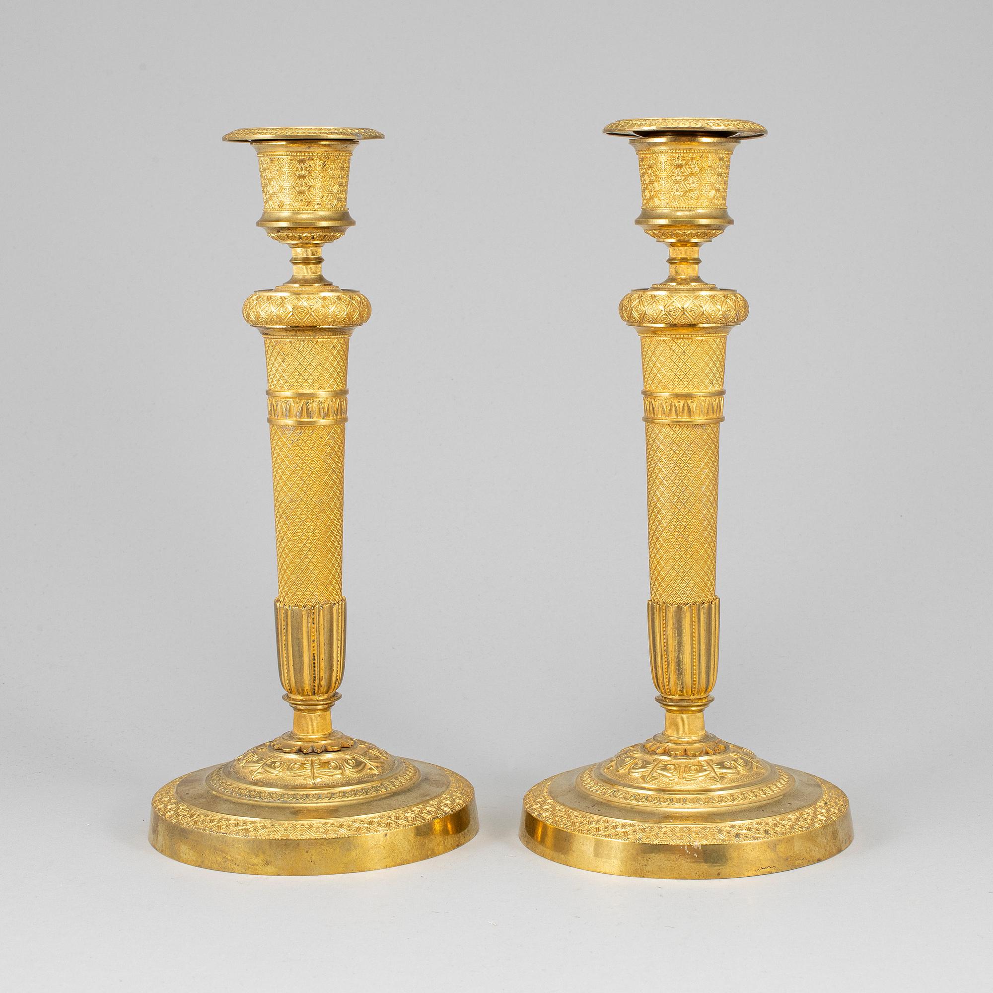 A pair of ormolu candlesticks, first half of the 19th century.