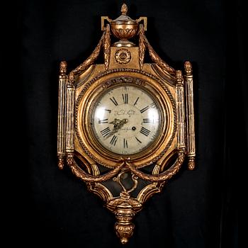 A Gustavian wall hanged clock, dial marked "Jacob Kock Stockholm", maded in the second half of the 18th century.