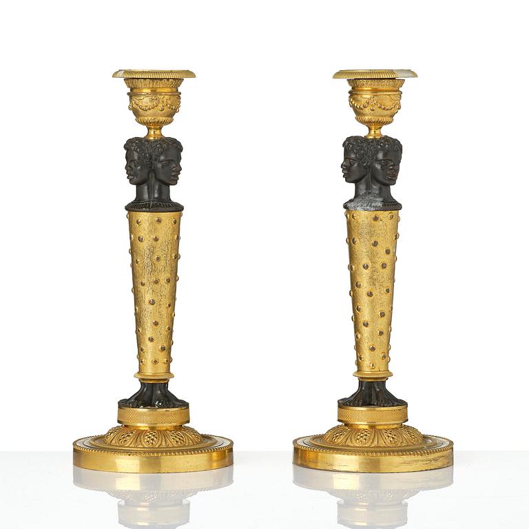 A pair of Napoleon III gilt and patinated bronze candlesticks, later part 19th century.