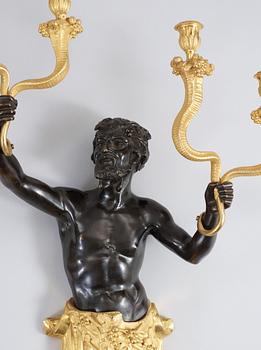 A pair of Louis Philippe 1830/1840's gilt and patinated bronze four-light wall-lights.