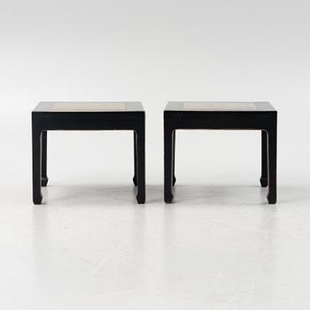 A pair of blac painted side tables with stone tops.