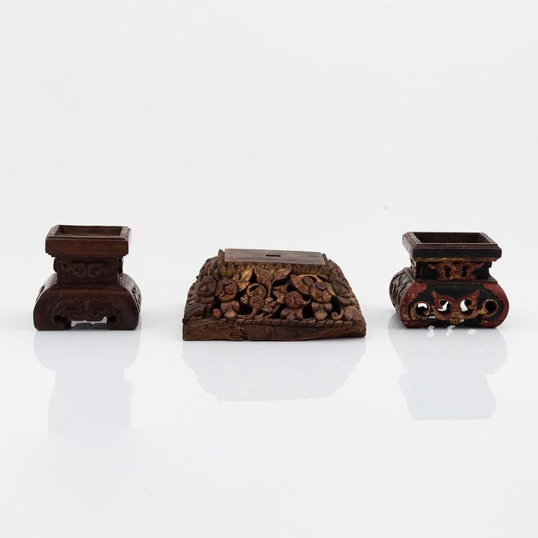 A set of three carved wooden stands, early 20th Century.