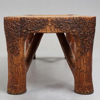 Gustaf Fjaestad, an Art Nouveau carved pine table, Arvika Sweden 1914, a double to the table in the Thiel Collection,