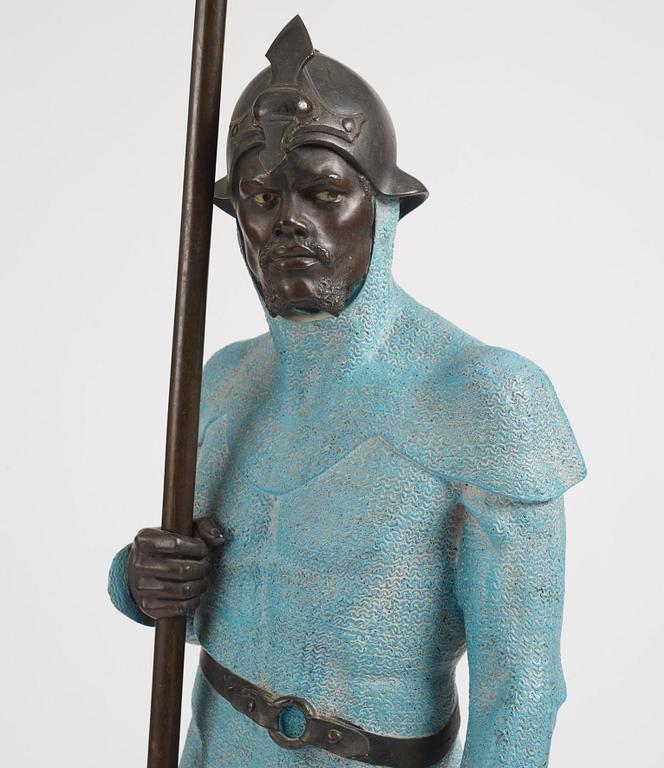 A bronze sculpture of a man in armour, late 19th century.