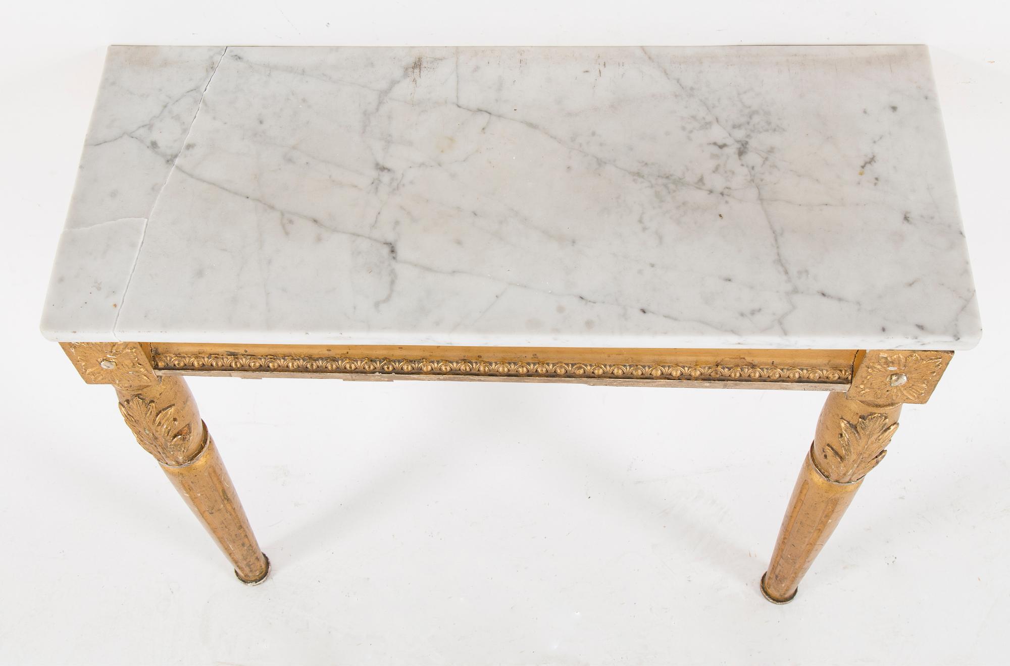 A Swedish Gustavian style mirror and console table with marble top from the first half of the 20th century.