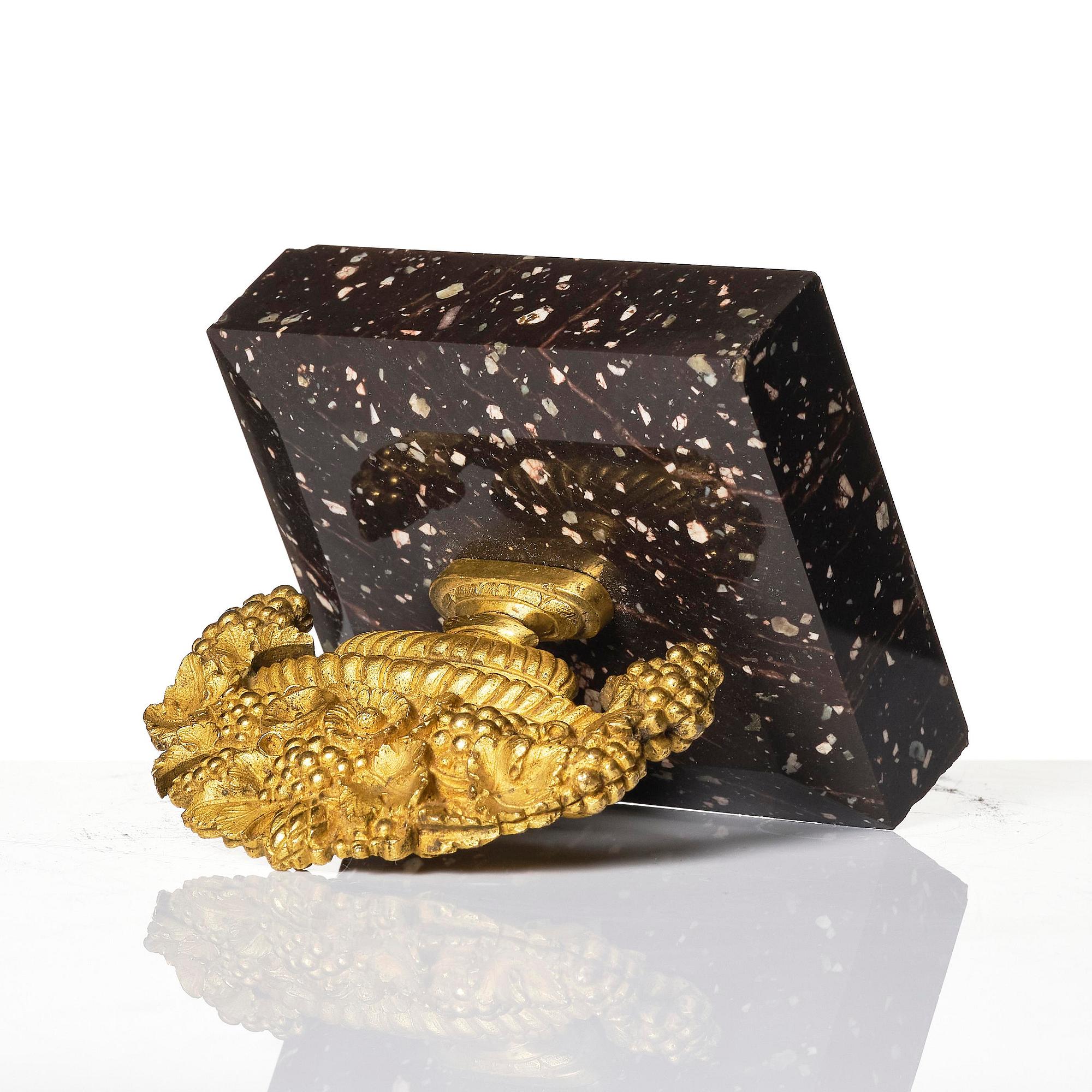 An Empire 'Loka-Risberg'-porhyry and ormolu paperweight, Älvdalen, early 19th century.