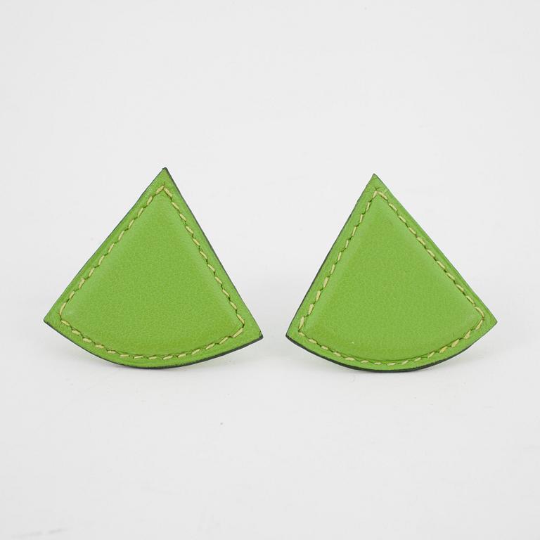 HERMÈS, a pair of green leather clip earings from the 1990s.