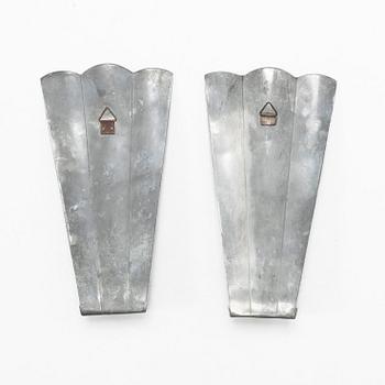Nils Fougstedt, a matched pair of pewter and brass wall sconces, model A 60, Svenskt Tenn, Stockholm 1929 and 1932.