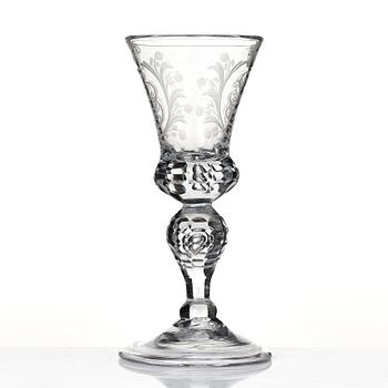 A cut and engraved glass goblet, dated 1755.