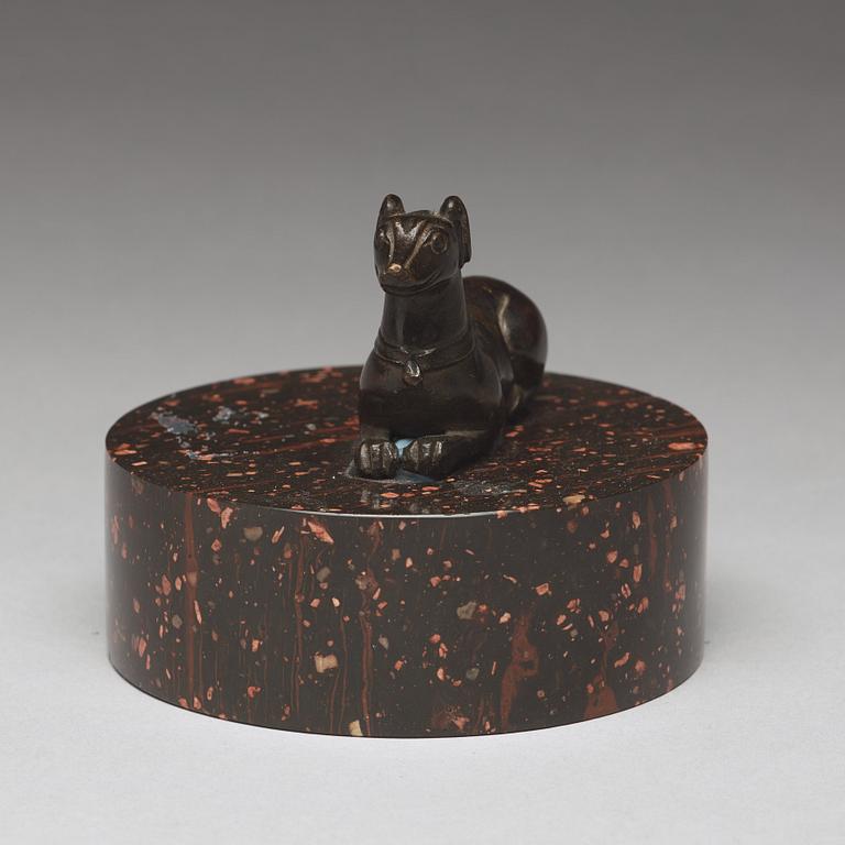 A bronze figure of a reclining dog, 17/18th Century.