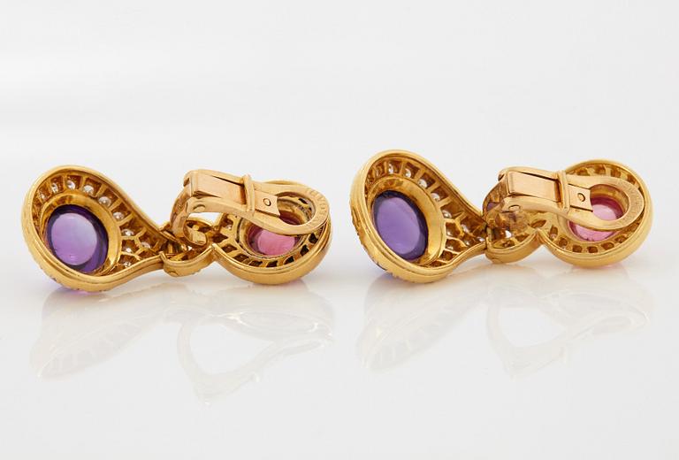 A pair of 18K gold Bulgari earrings set with cabochon-cut amethyst and tourmaline.