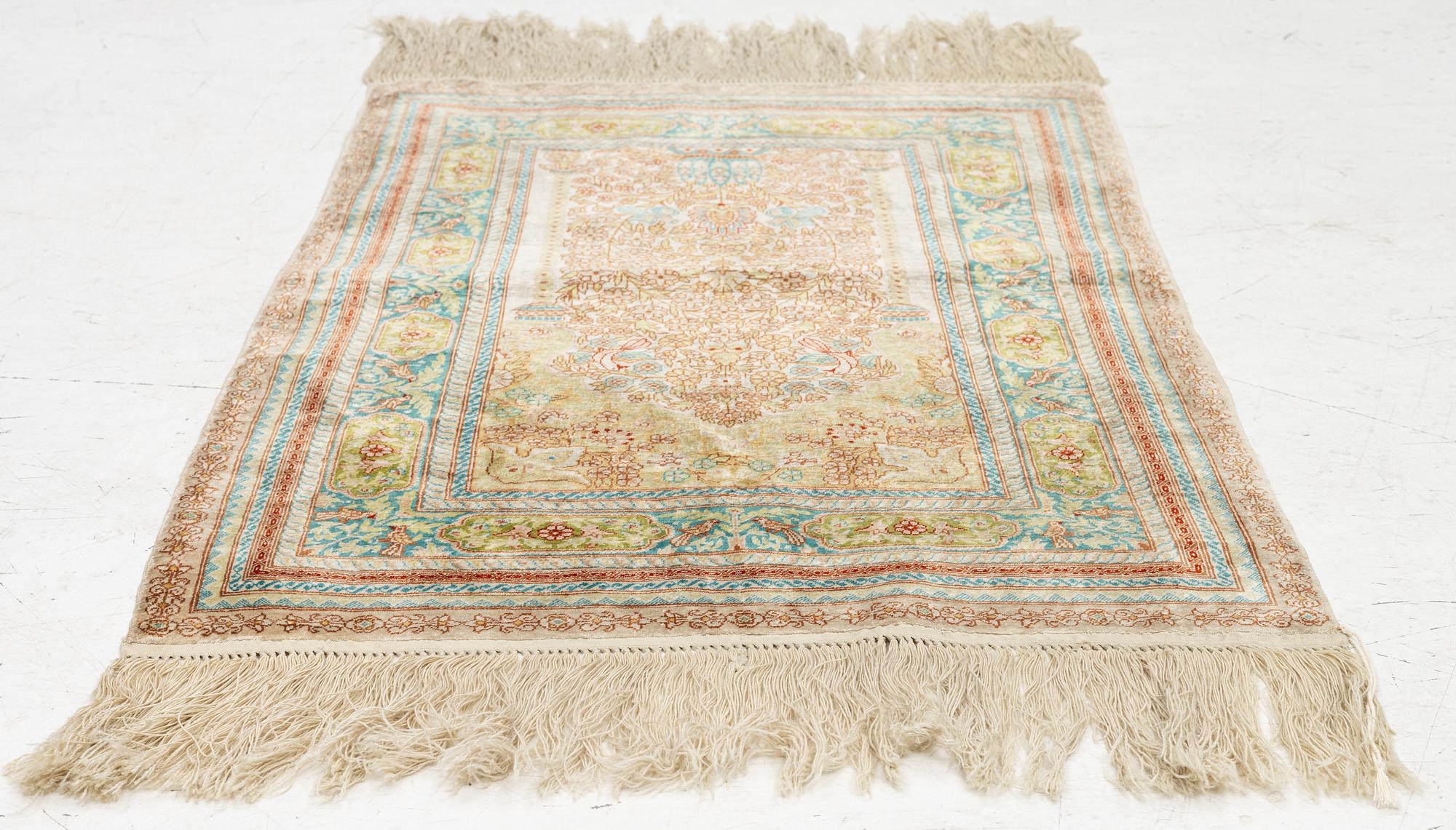 A semi-antique silk Hereke, c. 92 x 61 cm.