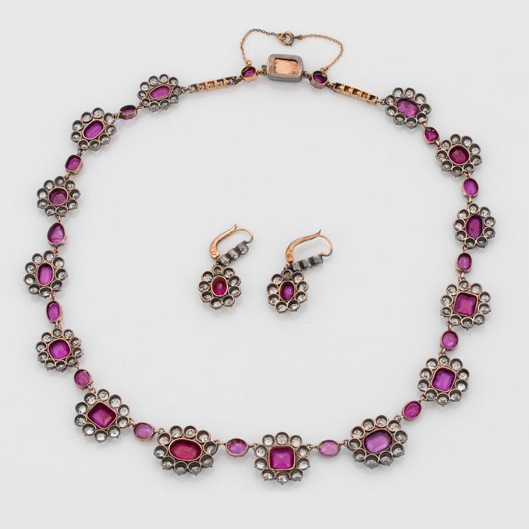 A Demi parure comprising a necklace and a pair of earrings set with rubies and old-cut diamonds.