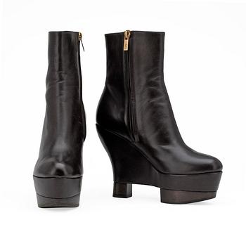 748. YVES SAINT LAURENT, a pair of brown leather wedge heeled platform boots.