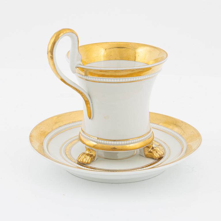 An Empire style porcelain cup and saucer, Germany, circa 1900.