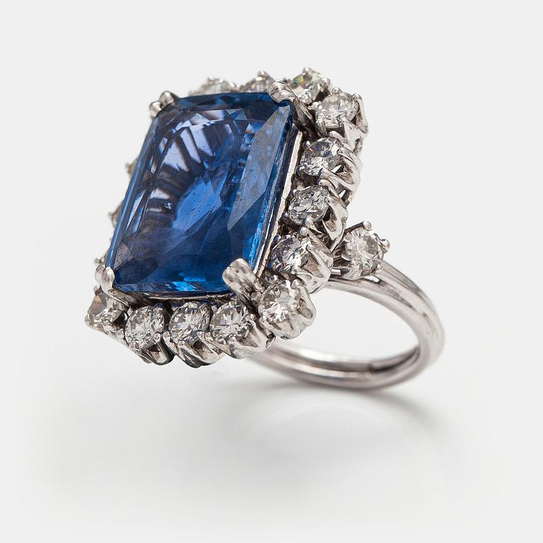 A platinum ring with a ca. 18.00 ct sapphire and ca. 3.00 cts of diamonds. With certificates.