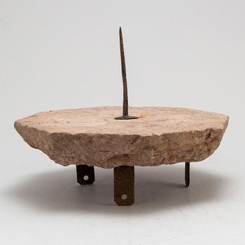 A limestone and iron sundial dated 1732.