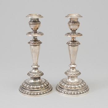 A pair of silver candle sticks, dated 1903.