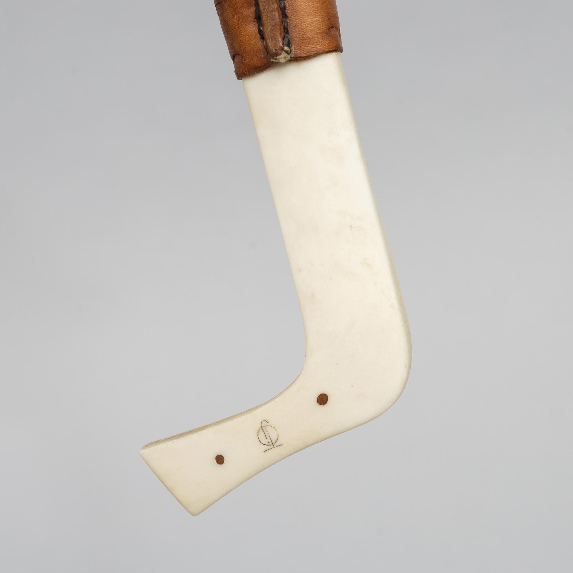 Oskar Tjäder, A reindeer horn knife, signed.