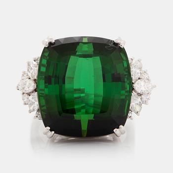 An 18K white gold ring set with a green tourmaline and round- and marquise brilliant-cut diamonds.