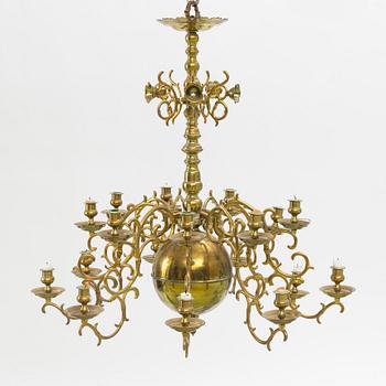 A baroque-style eighteen-branch brass chandelier, late 19th century.