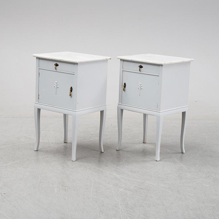 A pair of painted bedside tables with marble tops, 1920's.