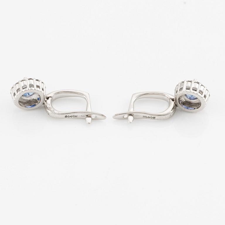 A pair of 14K gold earrings with faceted sapphires.