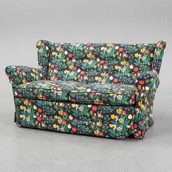 A sofa and wingback chair, later part of the 20th Century.