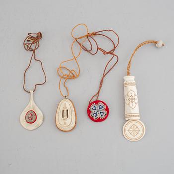 Four Sami pendants, reindeer horn, birch and embroidery with silver thread, one signed TF for Torsten Fankki.
