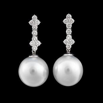 883. A pair of cultured South sea pearl and diamond earrings. Ø 14.7 - 15 mm. Total carat weight of diamonds circa 1.34 cts.