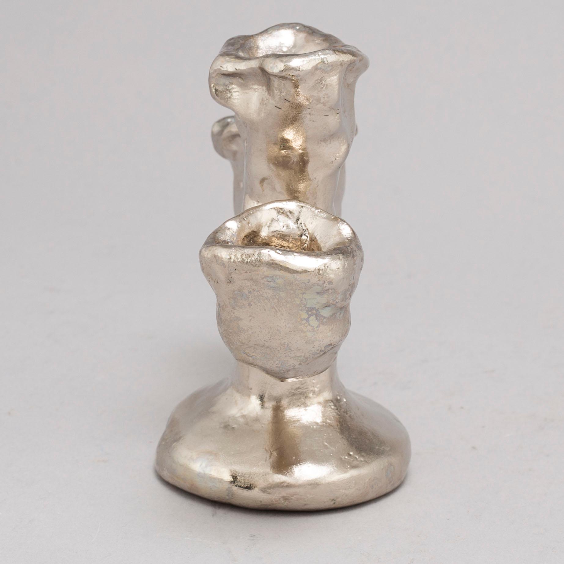DAN WOLGERS, a silvergilt bronze candle stick, signed.