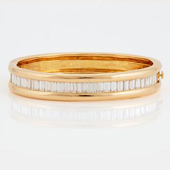 An 18K gold bracelet set with baguette-cut diamonds 7.715 cts according to engraving.