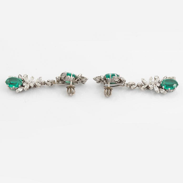 A pair of 18K white gold earrings set with round brilliant- and navette-cut diamonds and green synthetic stones.