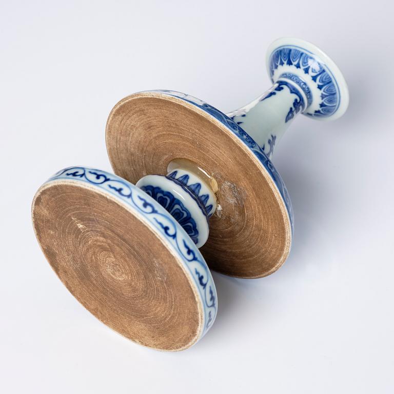 A pair of blue and white pricket candle sticks, with a poem, Qing dynasty with a Qianlong mark and of the period.