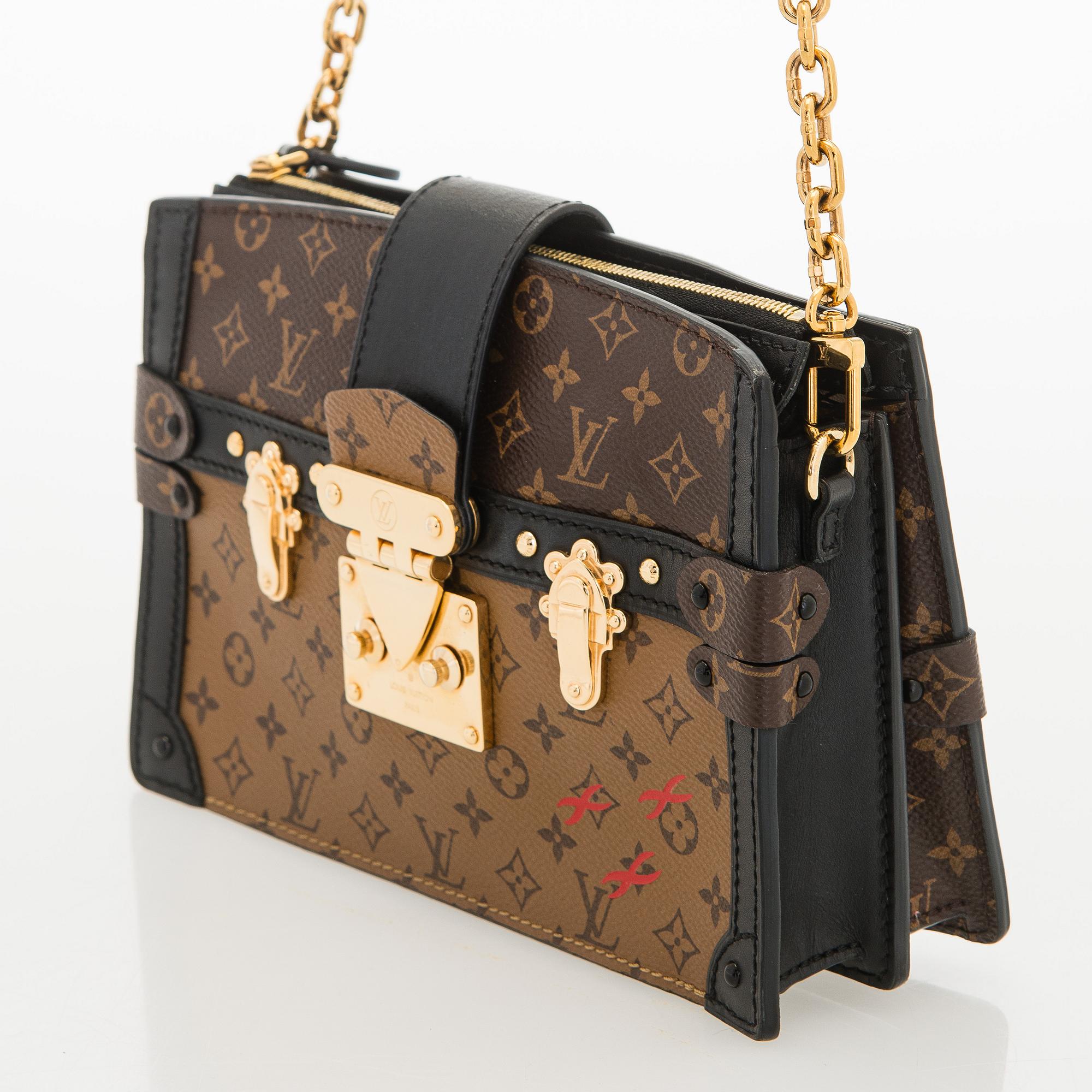 Louis Vuitton, a "Reverse Monogram Trunk Clutch" bag.
