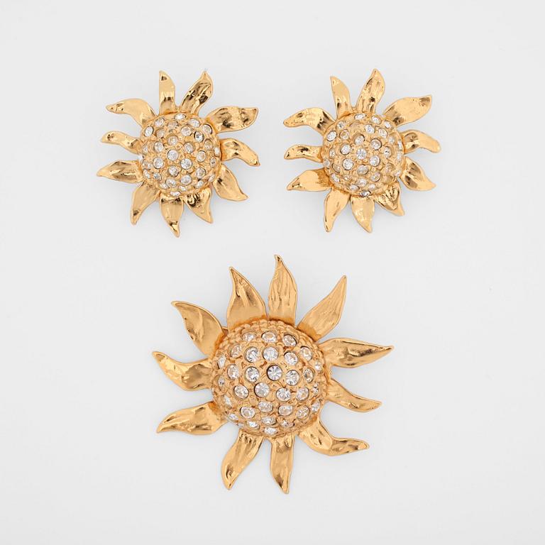 YVES SAINT LAURENT, a pair of gold colored and rhinestone embellished clip earrings and brooch.
