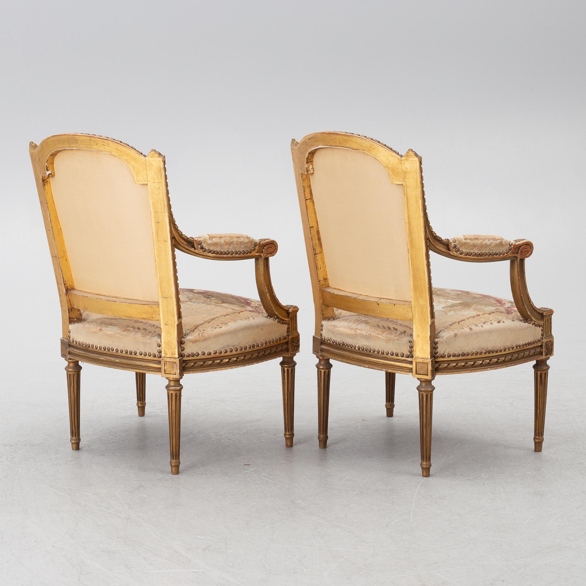 A pair of Louis XVI-style armchairs, late 19th century with 18th century fabric.