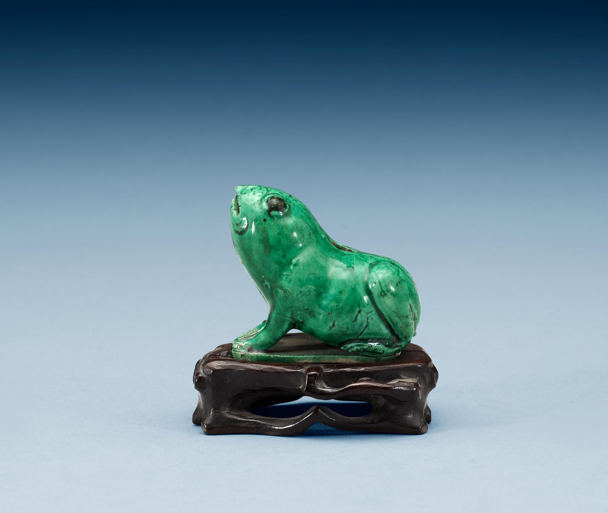 A green glazed biscuit water dropper, in the shape of a frog, Qing dynasty, Kangxi (1662-1722).
