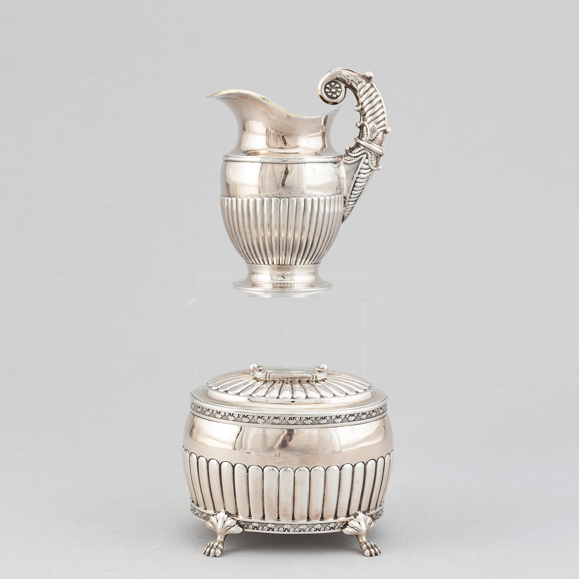 A silver creamer by Johan Petter Ahlforss, Strängnäs, 1833 and a silver sugar box, Kristianstad, 1928.